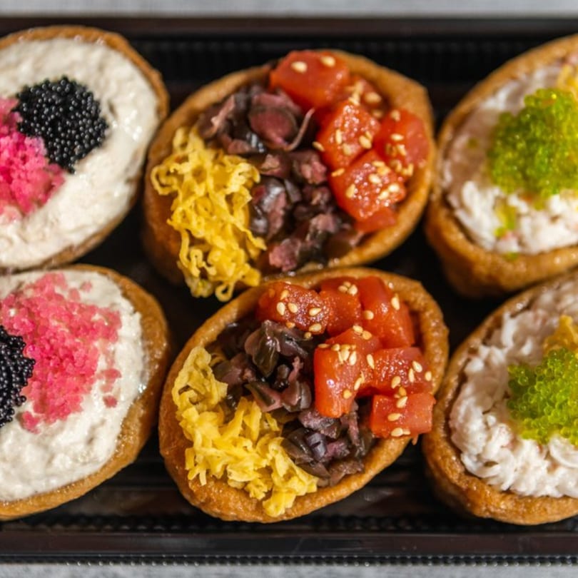 Six Iro Sushi "Stuff x Roll" inari sushi, three with tuna, beef, and egg, and three with crab and roe.